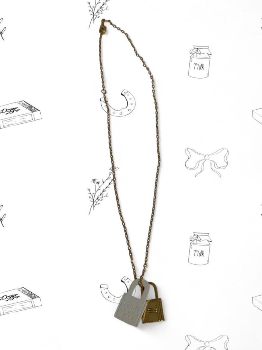 Hermes gold padlock necklace with white leather tag